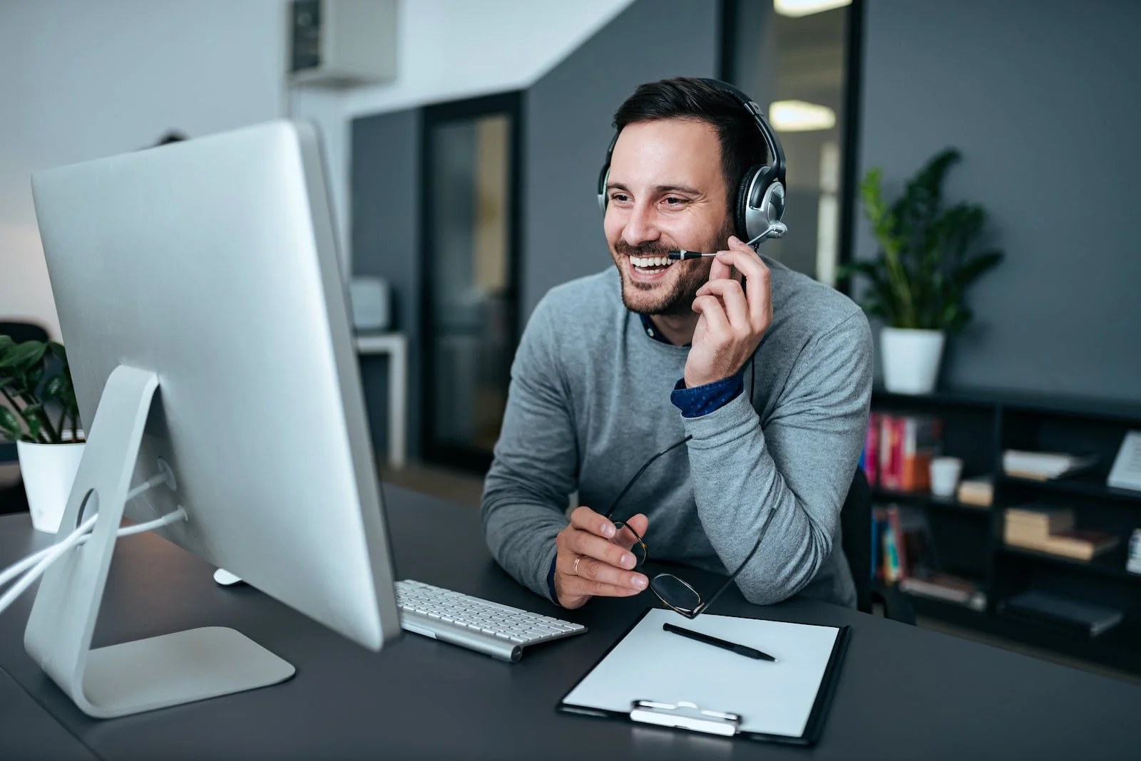 customer server representative smiling at desk